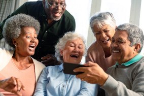 Diverse group of seniors talking to someone on the phone