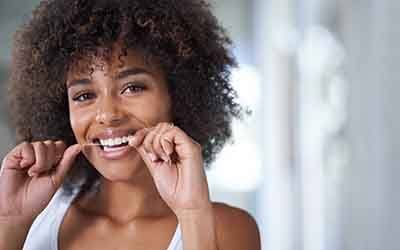 Picture of a woman flossing