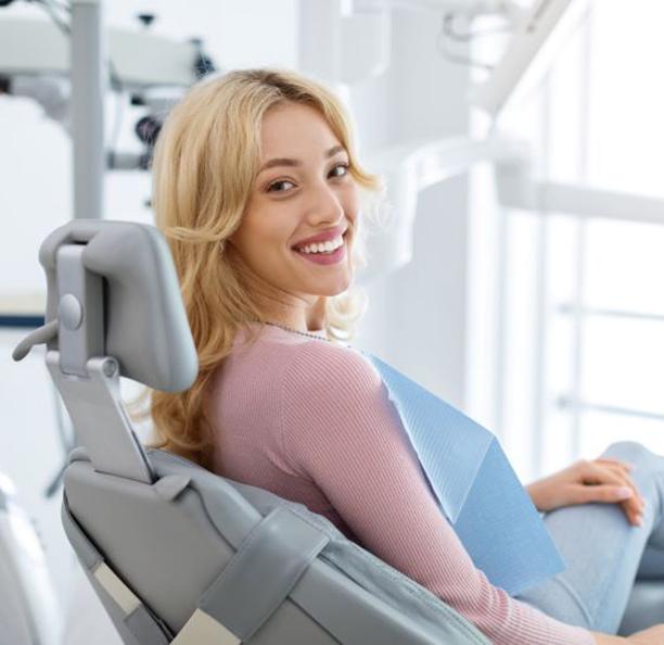 Happy dental patient looking over her shoulder